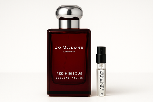 Jo Malone Red Hibiscus Cologne Intense 1ml sample standing next to 100ml perfume bottle of Jo Malone Red Hibiscus Cologne Intense which has white writing on dark red bottle